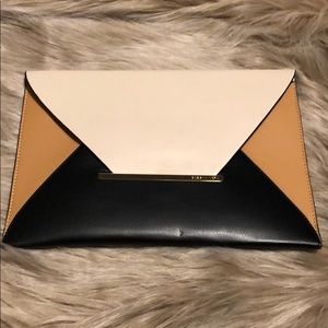 Tri-tone leather envelope clutch.